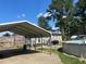 Home exterior featuring carport, pool, fenced backyard, and a grill at 412 Nc-82, Dunn, NC 28334