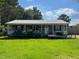 Charming single-story home with a welcoming porch, ramp, and green front lawn at 412 Nc-82, Dunn, NC 28334