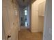 Tiled hallway with multiple doors and access to storage space and other rooms at 412 Nc-82, Dunn, NC 28334
