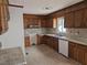 Traditional kitchen with wood cabinets, laminate countertops, tile floors and backsplash, plus a window at 412 Nc-82, Dunn, NC 28334
