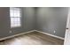 Cozy bedroom with luxury vinyl plank flooring, natural light, and fresh paint at 471 Merriman St, Henderson, NC 27536