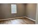 Bedroom with neutral paint, and wood-look flooring at 471 Merriman St, Henderson, NC 27536