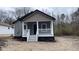 Charming single-story home featuring a welcoming front porch and newly installed steps, complemented by fresh landscaping at 471 Merriman St, Henderson, NC 27536