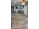 Open-concept layout showcases a modern kitchen with gray cabinets, stainless steel appliances, and luxury vinyl plank flooring at 471 Merriman St, Henderson, NC 27536