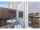 Cozy outdoor balcony with table and chairs and partial privacy fence. Enjoy the neighborhood views at 5818 Humanity Ln, Raleigh, NC 27616