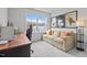 Comfortable bedroom featuring a neutral couch, a desk, movie posters, and a light-filled window at 5818 Humanity Ln, Raleigh, NC 27616