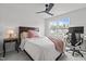 Bright bedroom with a ceiling fan, queen bed, and a window view of the houses across the street at 5818 Humanity Ln, Raleigh, NC 27616
