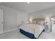 Bright bedroom featuring neutral colors, a comfortable bed, matching lamps, and natural light at 5818 Humanity Ln, Raleigh, NC 27616