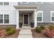 Charming home entrance with a decorative door, potted plants, and craftsman-style architecture at 5818 Humanity Ln, Raleigh, NC 27616