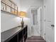 Hallway leading to bathroom featuring a vintage window frame wall decor, a lamp, and wood-style floors at 5818 Humanity Ln, Raleigh, NC 27616