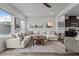 Comfortable living room with an oversized sectional, dark accents, and lots of natural light at 5818 Humanity Ln, Raleigh, NC 27616
