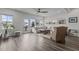 Bright living room features hardwood floors, a large sectional, and access to the outdoor patio at 5818 Humanity Ln, Raleigh, NC 27616
