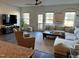 Relaxing living area with lots of light, comfortable seating, and access to the outside balcony at 5818 Humanity Ln, Raleigh, NC 27616