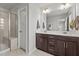 A spacious main bathroom featuring double sinks, a walk-in shower, and a large mirror at 5818 Humanity Ln, Raleigh, NC 27616