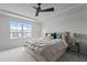 Calm bedroom with a large window, tray ceiling, king bed, and decorative headboard at 5818 Humanity Ln, Raleigh, NC 27616