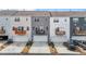 Three-story townhomes featuring garages and balconies with views of neighborhood at 5818 Humanity Ln, Raleigh, NC 27616