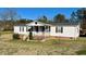 Cozy, single-story home with a covered porch and tidy landscaping at 59 Willow Lake Rd, Roxboro, NC 27574