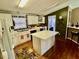 The kitchen features an island, white cabinets, and an adjacent dining room at 59 Willow Lake Rd, Roxboro, NC 27574