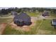 Aerial view of a new construction home with dark roof in a grassy community at 70 Prency Ln, Middlesex, NC 27557