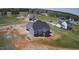 Aerial view of the back of a gray home showcasing its surrounding landscape and neighborhood at 70 Prency Ln, Middlesex, NC 27557