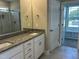Beautiful bathroom with double vanity, granite countertops, large mirror, and walk-in shower with a large walk-in closet at 70 Prency Ln, Middlesex, NC 27557