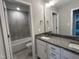 Bathroom featuring a granite-look vanity with double sinks and a tiled shower at 70 Prency Ln, Middlesex, NC 27557