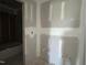 Unfinished bathroom with drywall, fixtures and adjacent room at 70 Prency Ln, Middlesex, NC 27557