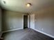 A bedroom with carpet, gray walls and closet with sliding doors at 70 Prency Ln, Middlesex, NC 27557