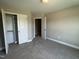 A bedroom with carpet, gray walls and closet with sliding doors at 70 Prency Ln, Middlesex, NC 27557