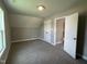 Bedroom featuring neutral carpet, gray walls, and an open door leading to the hallway at 70 Prency Ln, Middlesex, NC 27557