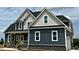 The home features gray siding, white trim, white windows, black roof, and a welcoming front porch at 70 Prency Ln, Middlesex, NC 27557