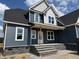 New two story home featuring stone accents on the front porch and blue vinyl siding at 70 Prency Ln, Middlesex, NC 27557
