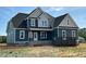 New home with blue siding, white trim, and a dark roof, showcasing modern design and construction at 70 Prency Ln, Middlesex, NC 27557
