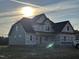 A partially finished home boasts a classic design with multiple windows under a sunny sky at 70 Prency Ln, Middlesex, NC 27557
