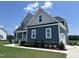 Charming two-story home with a well-manicured lawn, landscaped garden beds, and a welcoming front porch at 70 Prency Ln, Middlesex, NC 27557