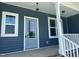 Charming home featuring a stylish front door, updated windows, and a welcoming porch with decorative lighting at 70 Prency Ln, Middlesex, NC 27557