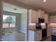 Kitchen featuring white cabinets, stainless appliances, and a view into the adjacent dining area at 70 Prency Ln, Middlesex, NC 27557