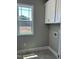 Laundry room with a window and built-in cabinets at 70 Prency Ln, Middlesex, NC 27557