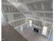 Open concept living area featuring a fireplace, high ceilings, and access to the outdoors at 70 Prency Ln, Middlesex, NC 27557