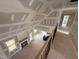 An elevated view of the unfinished living room with a fireplace and cathedral ceiling at 70 Prency Ln, Middlesex, NC 27557