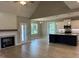 Open living room with fireplace, views to the kitchen, and lots of natural light at 70 Prency Ln, Middlesex, NC 27557
