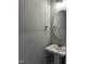 Elegant powder room features a round mirror, pedestal sink, and modern fixtures, designed for guest convenience at 70 Prency Ln, Middlesex, NC 27557