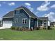 Two-story home features a well-maintained lawn, landscaping, a screened porch, and a two-car garage at 70 Prency Ln, Middlesex, NC 27557