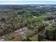Property nestled near a lake and forested areas with metal outbuildings at 765 Townsville Landing Rd, Henderson, NC 27537