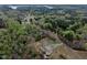Aerial view reveals the property is nestled in a serene, wooded area at 765 Townsville Landing Rd, Henderson, NC 27537