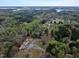 Aerial view shows the property near a lake with long driveway access and metal outbuildings at 765 Townsville Landing Rd, Henderson, NC 27537