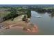 Aerial view showcasing the boat docks and lake, set amidst a backdrop of lush greenery at 765 Townsville Landing Rd, Henderson, NC 27537