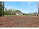 View of the home's backyard showing a screened-in porch and large grassy area at 765 Townsville Landing Rd, Henderson, NC 27537