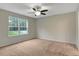 Spacious bedroom features plush carpet, neutral walls, and a ceiling fan at 765 Townsville Landing Rd, Henderson, NC 27537