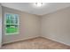 Bedroom features neutral carpet and a window with outdoor views at 765 Townsville Landing Rd, Henderson, NC 27537
